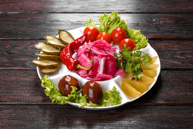 Delicious spicy pickles cut on a serving plate