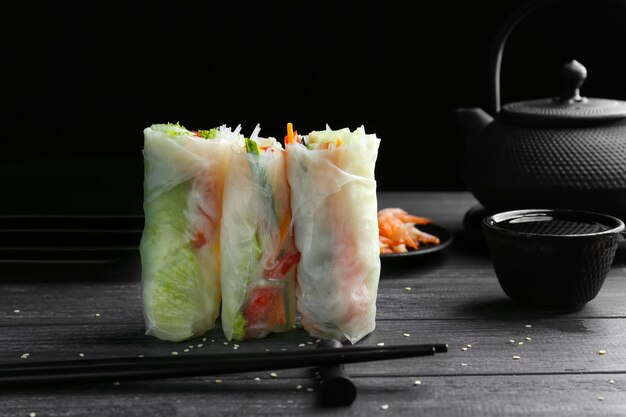 Delicious spring rolls on table