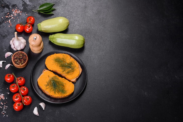 Delicious squash caviar sandwiches on a dark concrete background healthy breakfast