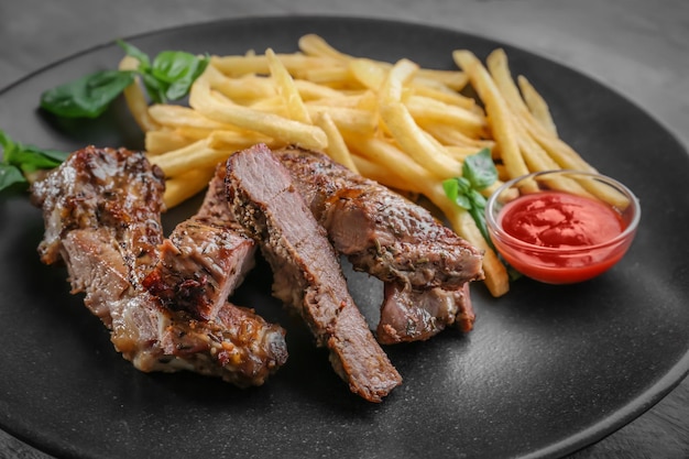 Delicious steak frites on plate closeup