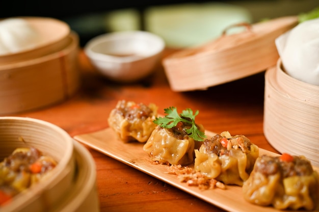 Delicious steamed shrimp or pork dumplings on a wooden plate