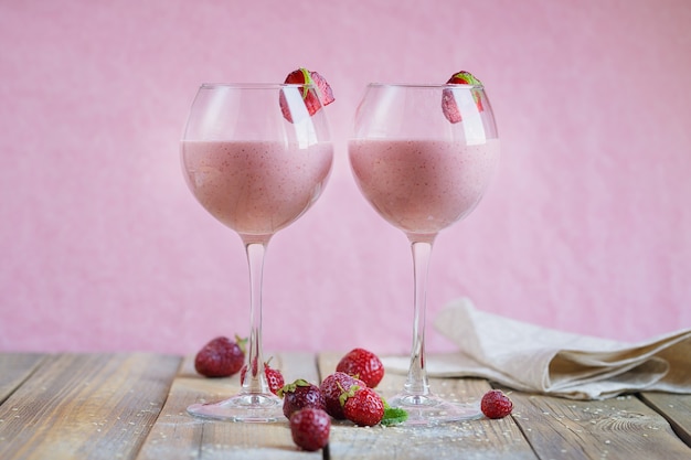 Delicious strawberry and banana smoothie, yogurt or milk shake with fresh berries