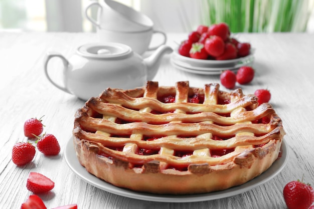 Delicious strawberry pie on table