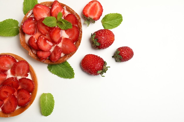 Delicious strawberry tarts on white background, space for text.