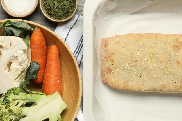 사진 맛있는 스트루델과 채소가 회색 나무 테이블에 평평하게 놓여 있습니다.