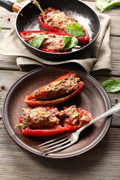 Delicious stuffed peppers on plate on table closeup