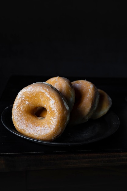 Delicious sugar donuts on a dark background