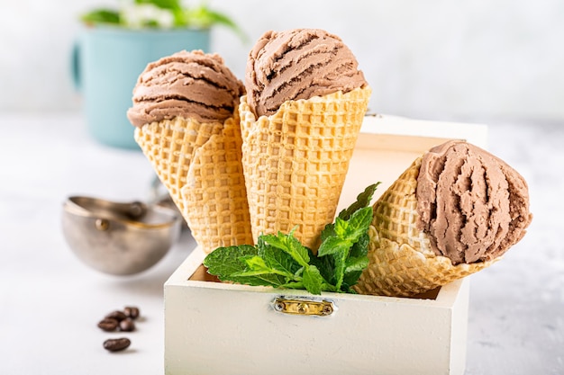 Delicious summer dessert coffee ice cream in waffle cone Summertime healthy food concept lactose free Copy space