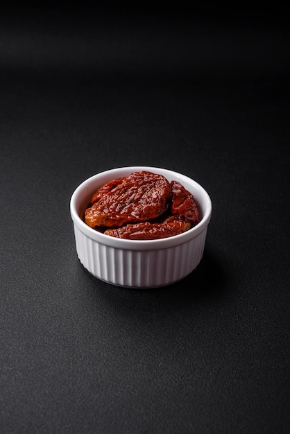 Delicious sun dried tomatoes in oil in a white ceramic bowl