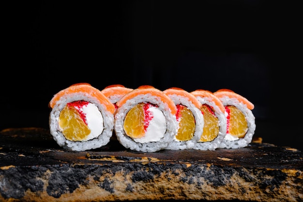 Delicious sushi roll on a stone plate