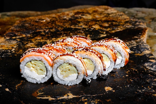 Delicious sushi roll on a stone plate