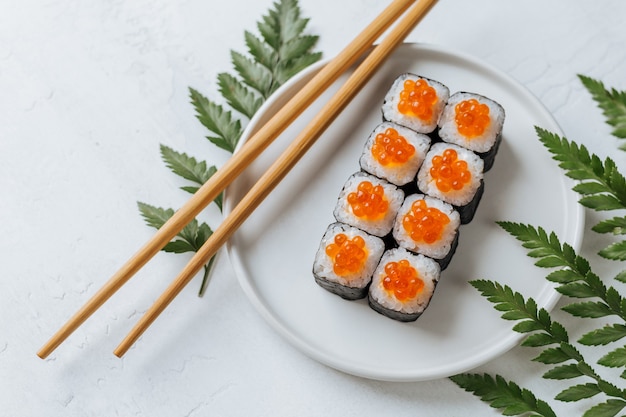 Delicious sushi rolls with cream cheese and red caviar