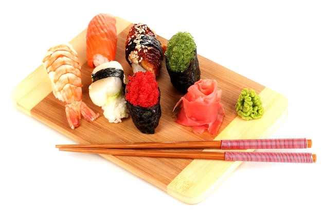 Delicious sushi served on wooden board isolated on white