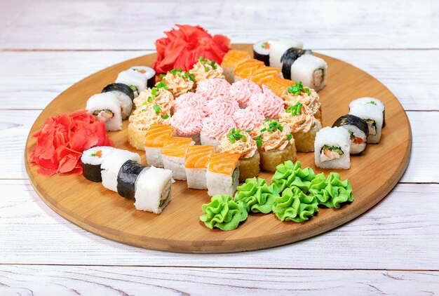 Delicious sushi set on wooden board.