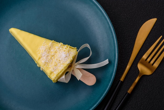 Delicious sweet cheesecake with fruits covered with icing with a wooden stick