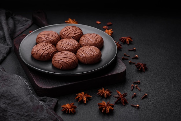 Delicious sweet chocolate cookies on a black ceramic plate