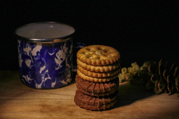 Delicious sweet chocolate cookies on a wooden table with low light