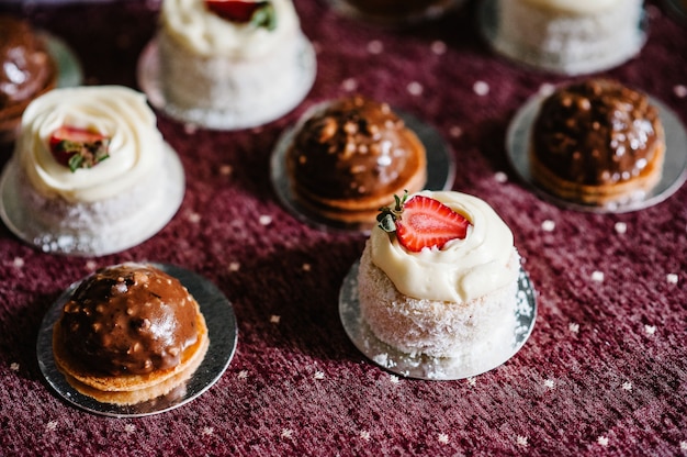 Delicious sweet chocolate and vanilla cakes with strawberries