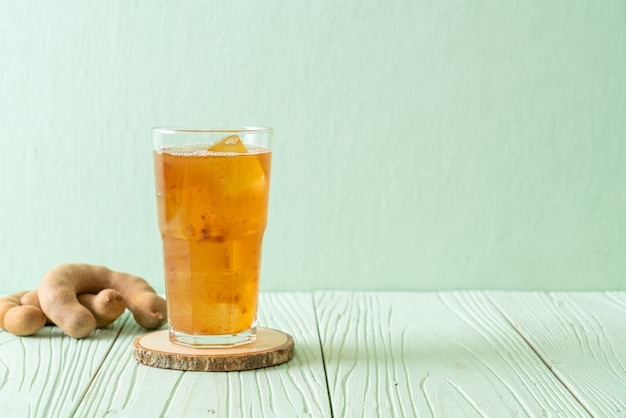 Delicious sweet drink tamarind juice and ice cube - healthy drink style