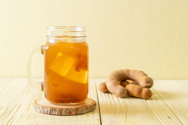 Delicious sweet drink tamarind juice and ice cube - healthy drink style