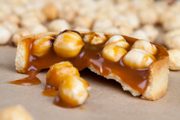 Delicious tartlet cake with soft caramel and roasted hazelnut