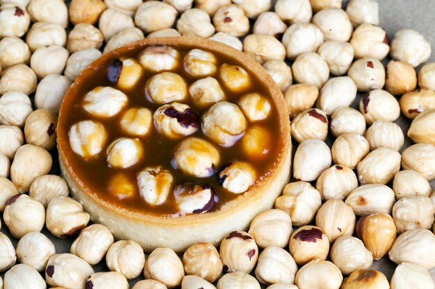 Delicious tartlet cake with soft caramel and roasted hazelnut