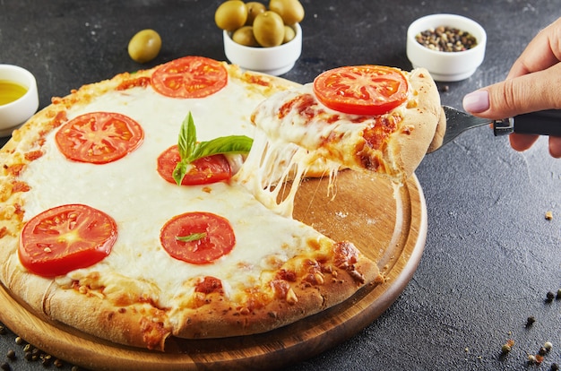 The delicious taste of pizza and slices of cheese with mozzarella and tomatoes.