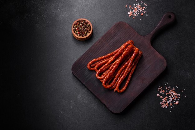 Delicious thin smoked meat sausages with spices and herbs