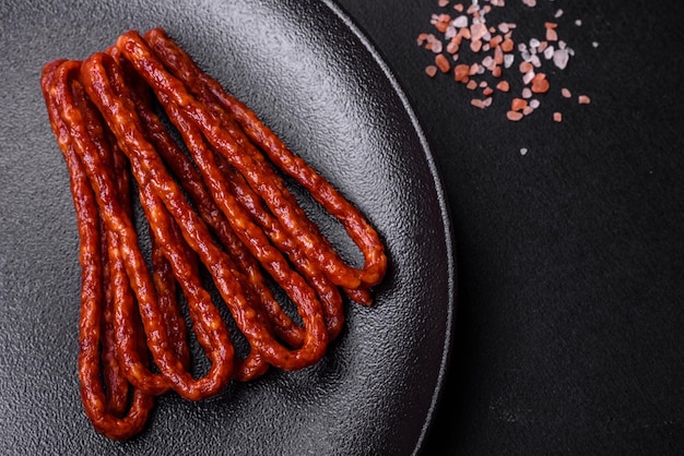 Delicious thin smoked meat sausages with spices and herbs