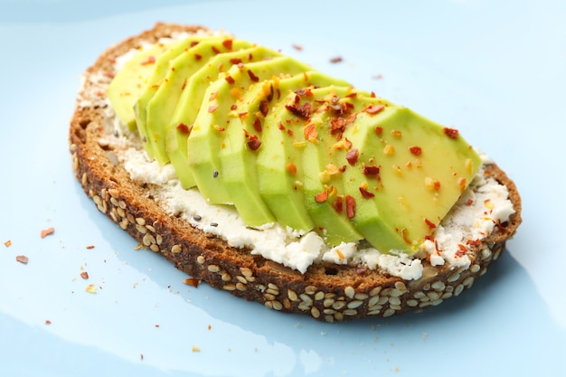 Delicious toast with avocado on white background