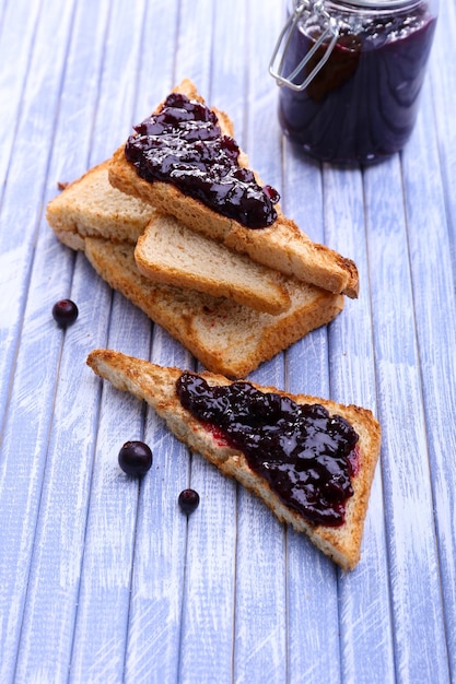 Delicious toast with jam on table closeup