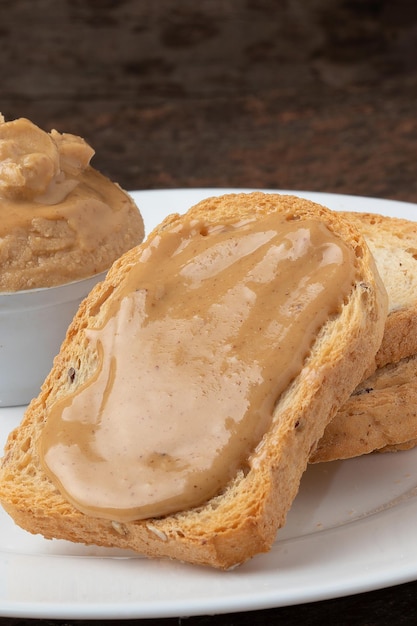 Delicious toasted bread with peanuts butter close up