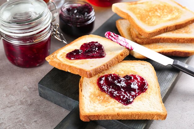 Delicious toasts with sweet jam on wooden board