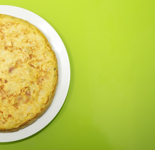Delicious traditional Spanish omelette freshly homemade omelette on a green background