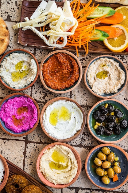 Delicious Turkish family breakfast table with pastries, vegetables, greens, spreads, cheeses, fried eggs, jams. Top view.