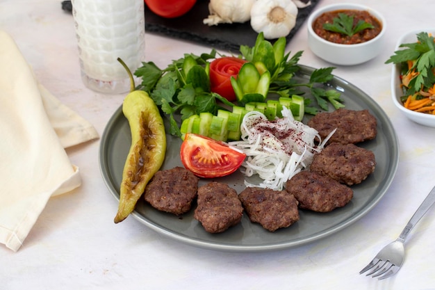 Delicious Turkish traditional kebab meatballs on white plate Turkish Food Kofte or Kofta meatball