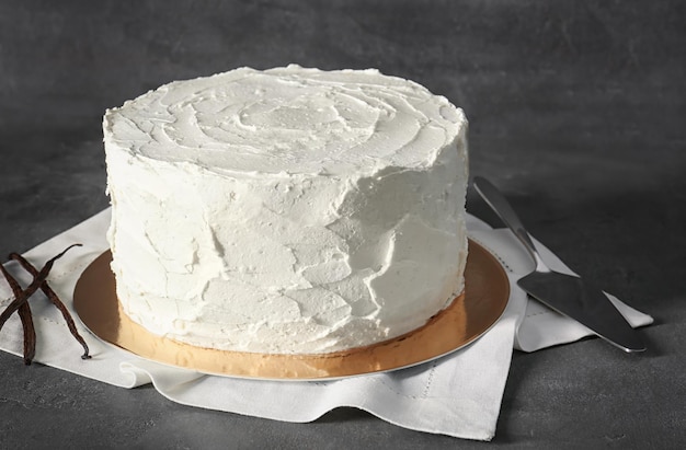 delicious vanilla cake with whipped cream on table