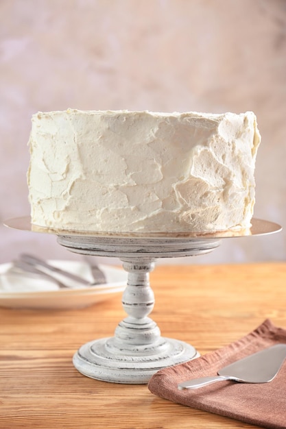 delicious vanilla cake with whipped cream on table