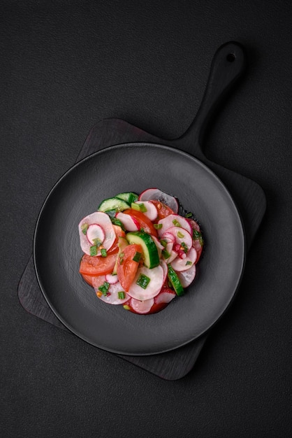 Delicious vegan salad of fresh vegetables of tomatoes cucumbers and radishes