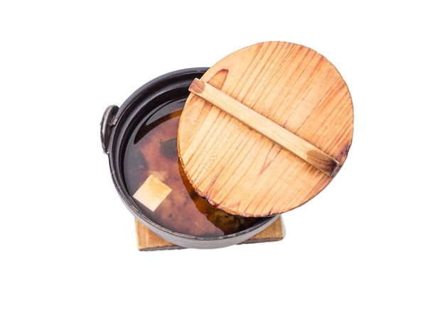 Delicious vegetable soup with tofu on old metal pot Isolated on a white background