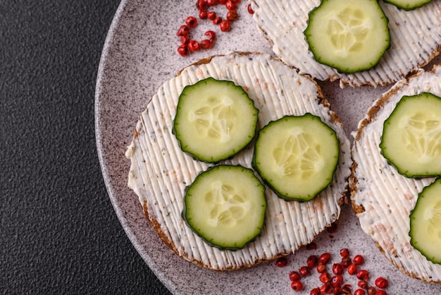 Delicious vegetarian sandwich with grilled toast cream cheese cucumbers and seeds