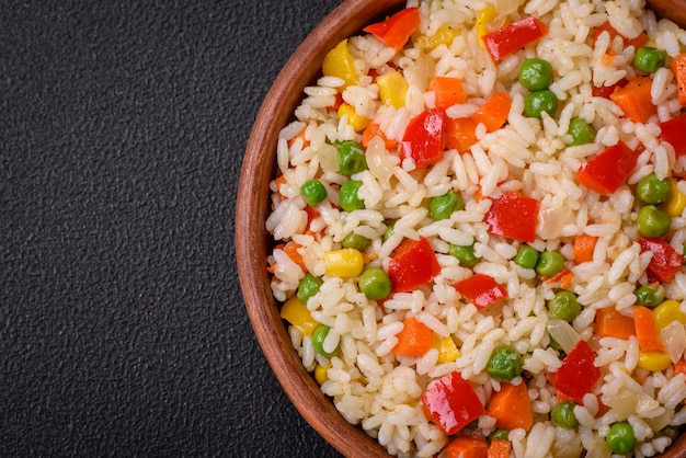 Delicious white boiled rice with vegetables sweet peppers carrots peas