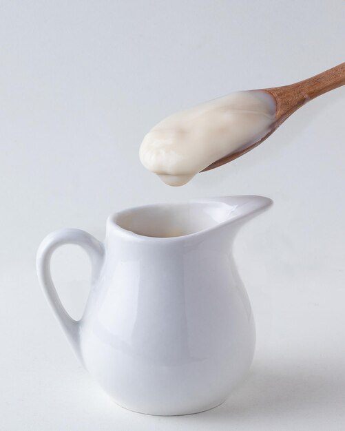 Delicious white chocolate cream on spoon