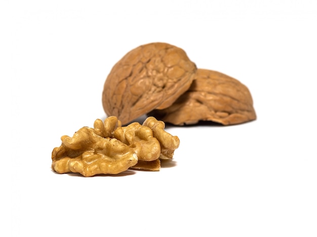 Delicious whole and broken walnuts, isolated on white background