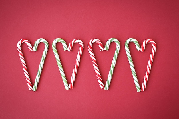 Delicious whole Christmas candy canes on a bright fullscreen background