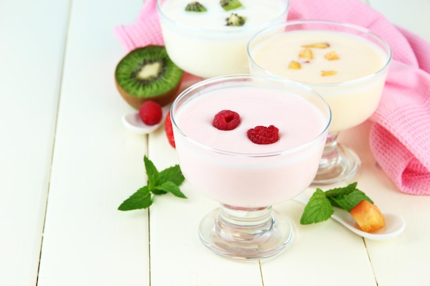 Delicious yogurt with fruit and berries on table closeup