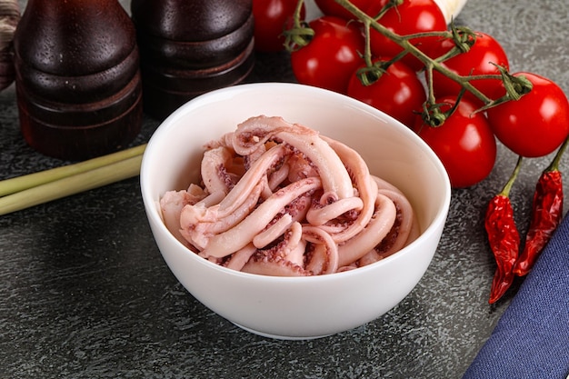 Delicous marinated squid tentacles snack in the bowl