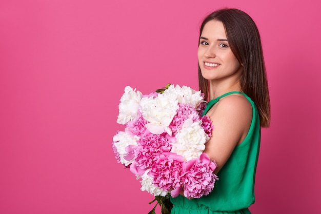 Delighted adorable brunette looking directly at camera.