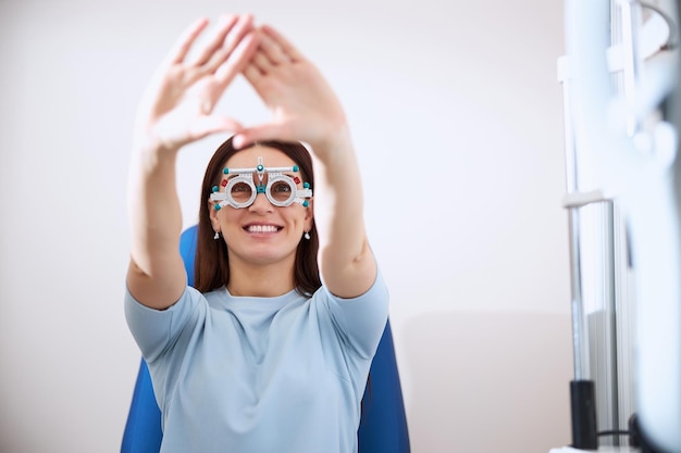 Delighted adult lifting her arms and bringing them together