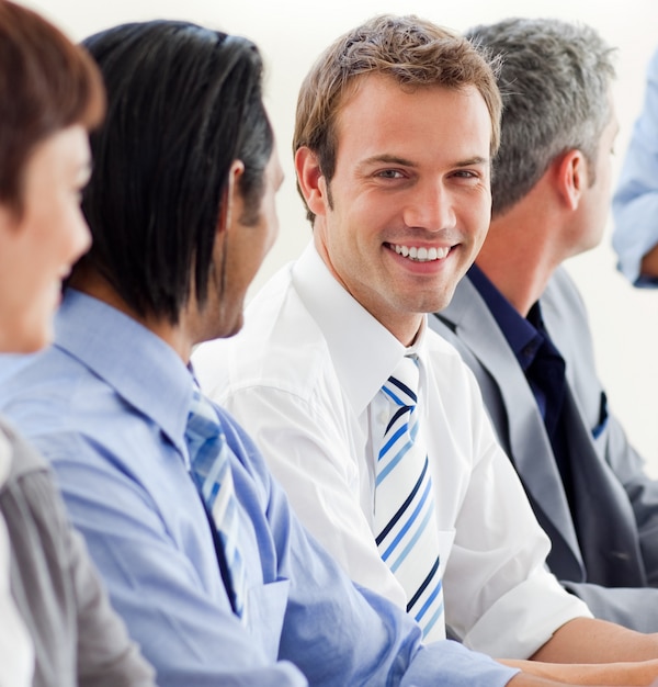 Delighted businessman looking at the camera in a meeting